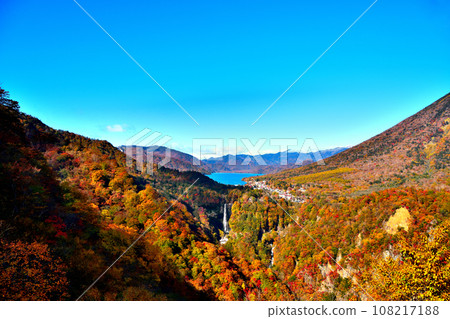 Nikko City, Tochigi Prefecture: Mt. Nantai, Lake Chuzenji, and Kegon Falls seen from Akechidaira Observation Deck, dyed with autumn leaves Nikko City, Tochigi Prefecture: Mt. Nantai, Lake Chuzenji, and Kegon Falls seen from Akechidaira Observation Deck, dyed with autumn leaves 108217188