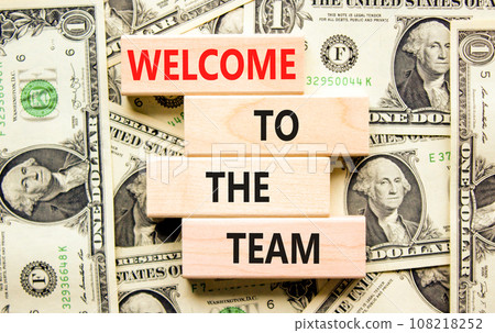 Welcome to the team symbol. Concept words Welcome to the team on wooden block. Dollar bills. Beautiful background from dollar bills. Business, motivational and welcome to the team concept. 108218252