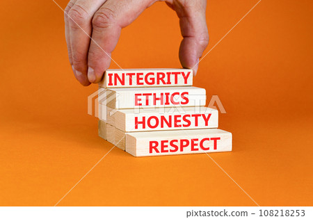 Integrity ethics honesty respect symbol. Concept word Integrity Ethics Honesty Respect on block. Beautiful orange background. Businessman hand. Business integrity ethics honesty respect concept. 108218253