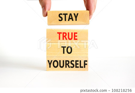 Stay true to yourself symbol. Concept word Stay true to yourself on beautiful wooden block. Beautiful white table white background. Businessman hand. Business stay true to yourself concept. Copy space 108218256