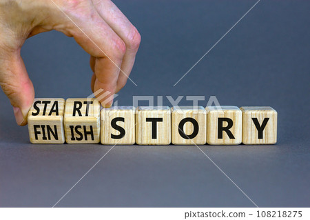 Start or finish story symbol. Concept words Start story and Finish story on wooden cubes. Beautiful grey table grey background. Businessman hand. Business start or finish story concept. Copy space Start or finish story symbol. Concept words Start story and Finish story on wooden cubes. Beautiful grey table grey background. Businessman hand. Business start or finish story concept. Copy space 108218275