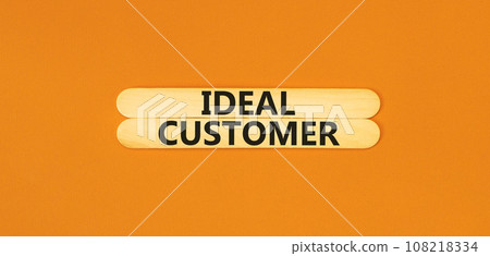 Ideal customer symbol. Concept words Ideal customer on beautiful wooden stick. Beautiful orange table orange background. Business ideal customer concept. Copy space. 108218334