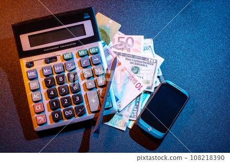 Calculator, smartphone and money. Brokerage business. Financial broker. View from above. 108218390
