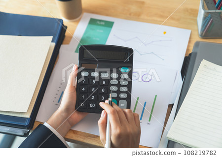 Accountant using calculator with financial documents on desk office. Accountant using calculator with financial documents on desk office. 108219782
