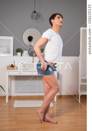 The man is wearing makeup. Transgender posing in the studio. The man is wearing makeup. Transgender posing in the studio. 108220135