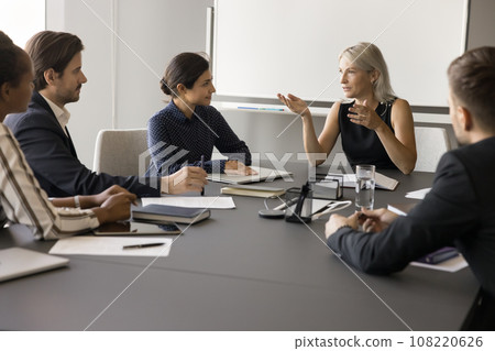 Serious mature coach, mentor woman training diverse staff Serious mature coach, mentor woman training diverse staff 108220626