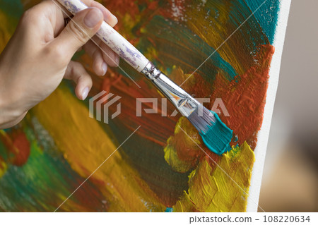 Artist makes brush strokes on canvas painting, close up Artist makes brush strokes on canvas painting, close up 108220634