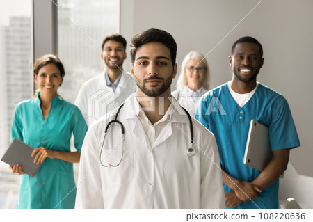 Positive attractive young Arab doctor wearing uniform, looking at camera Positive attractive young Arab doctor wearing uniform, looking at camera 108220636