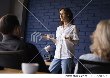 Young woman employee shares creative solution in group briefing 108220924