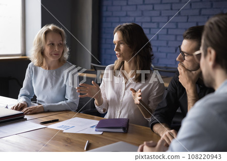 Attractive young businesswoman talking to partners at meeting Attractive young businesswoman talking to partners at meeting 108220943