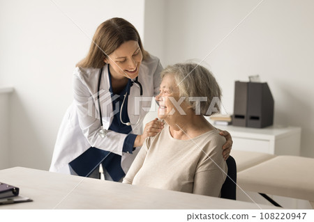 Happy medical worker touch older lady shoulder express support Happy medical worker touch older lady shoulder express support 108220947