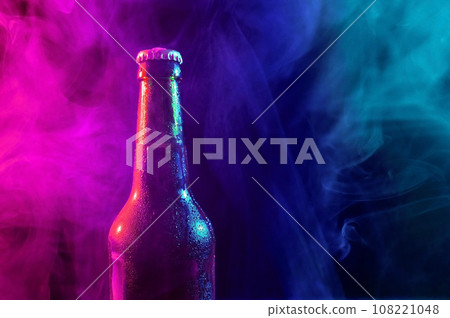 Glass bottle of beer in blue pink mist Glass bottle of beer in blue pink mist 108221048