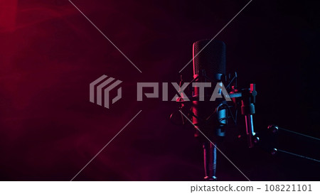 Professional microphone in red smoke on a black background. Professional microphone in red smoke on a black background. 108221101