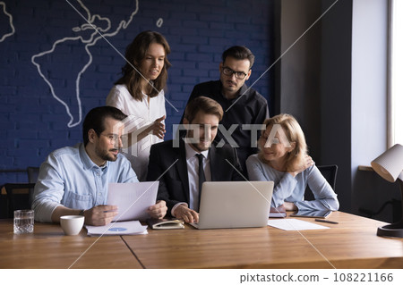 Five positive employees working together using computer Five positive employees working together using computer 108221166