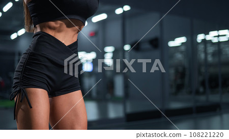 Faceless woman doing vacuum exercise in the gym. Faceless woman doing vacuum exercise in the gym. 108221220