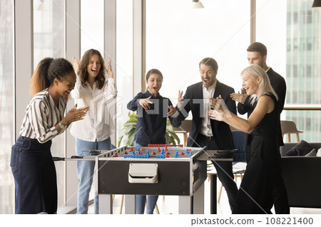 Joyful excited diverse business colleagues playing board football 108221400