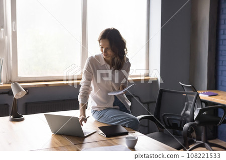 Young pretty woman busy working on computer in office Young pretty woman busy working on computer in office 108221533
