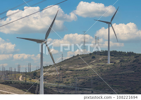 Wind turbines in desert, overcast sky - sunny day 108221694