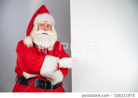 Santa claus points to an empty space. Christmas advertisement. 108221978