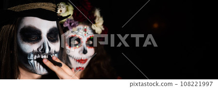 Man and woman in paired halloween costumes. Body art santa muerte and skeleton 108221997