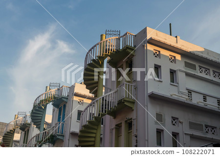 Colorful exterior spiral staircases against blue sky, Singapore Colorful exterior spiral staircases against blue sky, Singapore 108222071