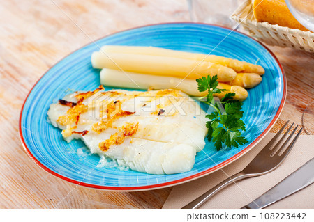 Deliciously roasted halibut fillet with asparagus and greens Deliciously roasted halibut fillet with asparagus and greens 108223442