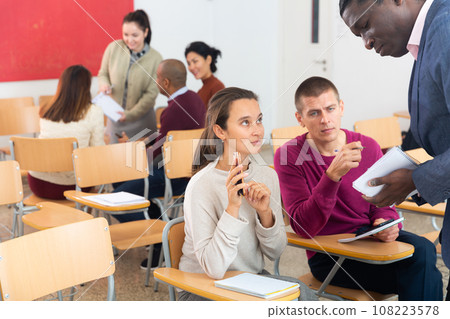 African american team leader holding meeting with diverse groupmates, explaining new project detail African american team leader holding meeting with diverse groupmates, explaining new project detail 108223578