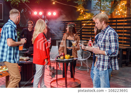 Friends having barbecue party in the backyard of the house. Friends having barbecue party in the backyard of the house. 108223691