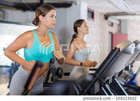 Young woman exercising on treadmill in gym 108223692