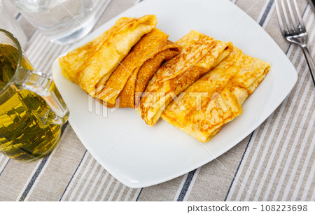 Delectable pancakes, featuring sweet fruit preserve filling 108223698