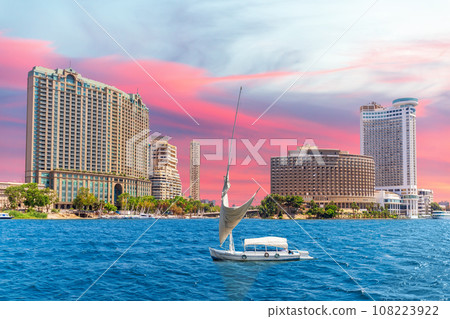 Nile river with fancy yacht and sunset sky over fashionable buildings of Cairo, Egypt 108223922