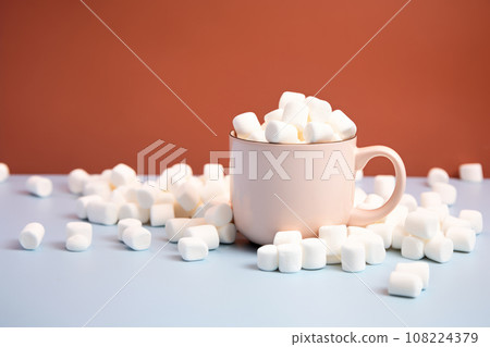 Hot cocoa with marshmallows or coffee in ceramic cup on white background. Autumn and Winter mood concept. Time for relax 108224379