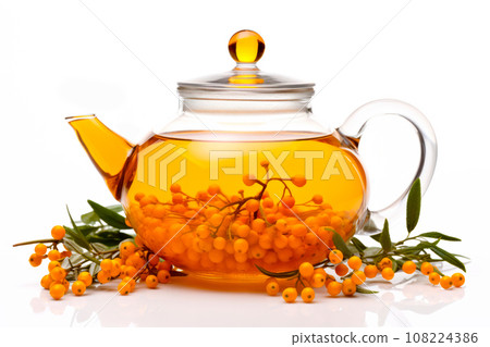 A glass teapot with sea-buckthorn berries, oolong tea in glass kettle isolated on white background. Chinese tea ceremony A glass teapot with sea-buckthorn berries, oolong tea in glass kettle isolated on white background. Chinese tea ceremony 108224386