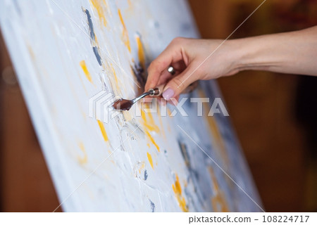 The artist paints an abstract painting using mastichin. The artist paints an abstract painting using mastichin. 108224717