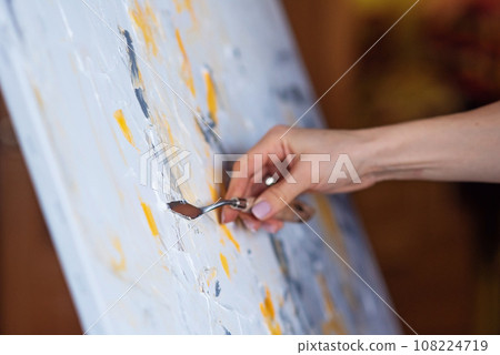 The abstract painting created with mastic and yellow paint. 108224719