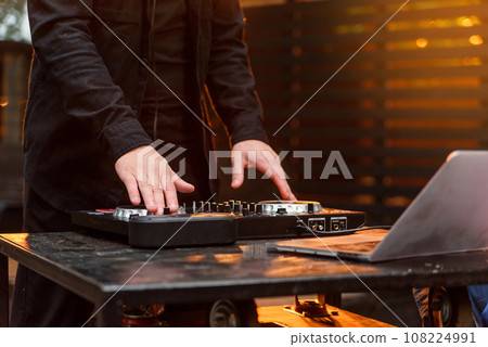 Close up of hands spinning the decks at the nightclub Close up of hands spinning the decks at the nightclub 108224991