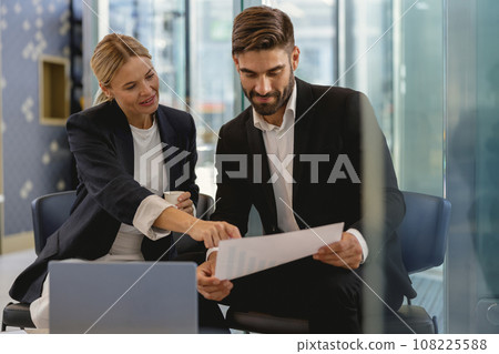 Business partners have meeting in cafe to solve biz issues and work with documets Business partners have meeting in cafe to solve biz issues and work with documets 108225588