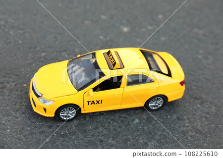Yellow taxi car model on city street Yellow taxi car model on city street 108225610