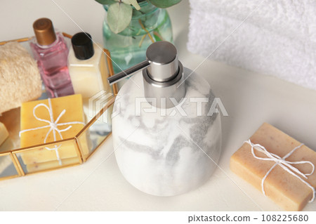 Marble soap dispenser and toiletries on white table Marble soap dispenser and toiletries on white table 108225680
