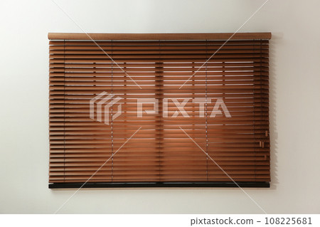 Window with closed brown blinds in room Window with closed brown blinds in room 108225681