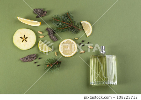 Flat lay composition with bottle of perfume on green background 108225712