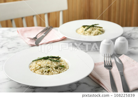 Delicious risotto with asparagus served on marble table 108225839