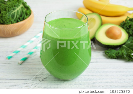 Tasty fresh kale smoothie on white wooden table, closeup 108225870