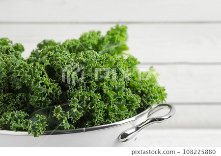 Fresh kale leaves against white background, closeup 108225880