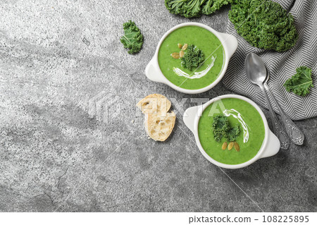 Tasty kale soup served on grey table, flat lay. Space for text 108225895