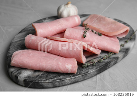 Tasty fresh ham served on light grey table Tasty fresh ham served on light grey table 108226019