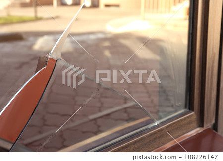 Broken window with sharp smithereens outdoors. Requiring repair Broken window with sharp smithereens outdoors. Requiring repair 108226147