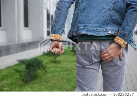 Man suffering from hemorrhoid pain outdoors, back view 108226257