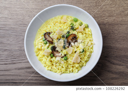 Delicious risotto with cheese and mushrooms on wooden table, top view Delicious risotto with cheese and mushrooms on wooden table, top view 108226292
