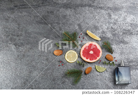 Flat lay composition with bottle of perfume on grey background, space for text 108226347